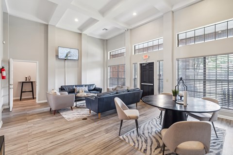 a living room with couches and chairs and a round table